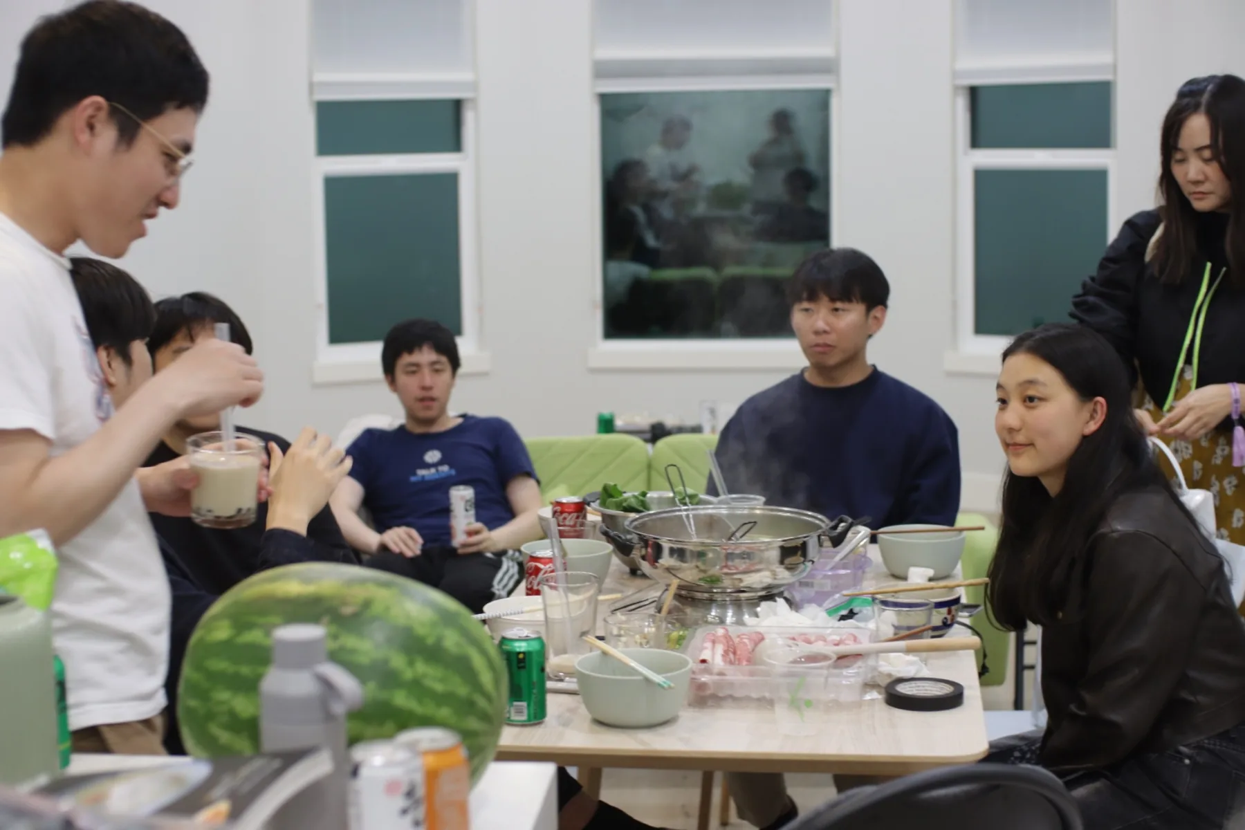 House members sharing hot pot together around the dinner table